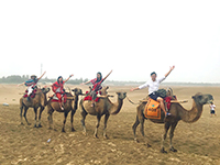 Riding camels under dust storm (Photo Credit: Miss Cui Yongjun; Programme Host: Lanzhou University)